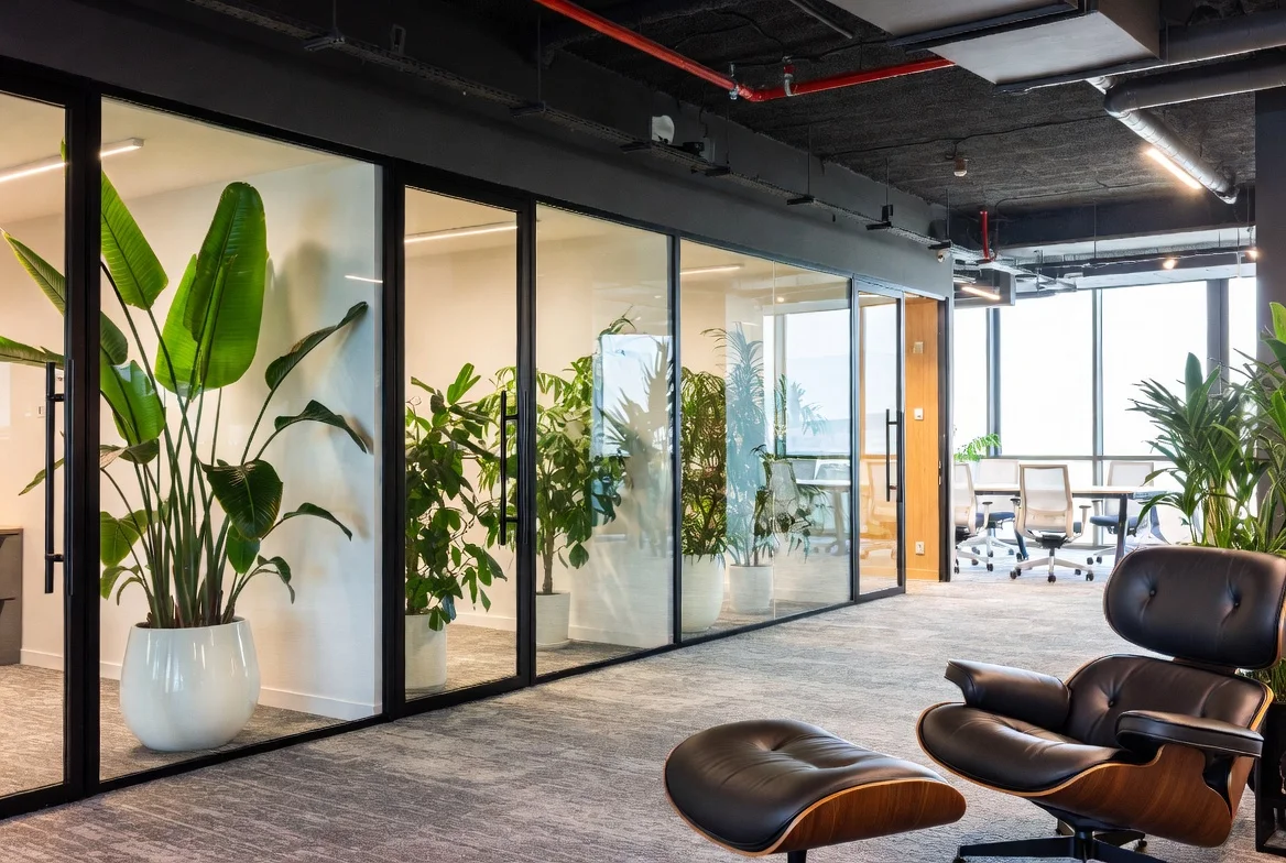 Modern office workspace with plants and a chair
